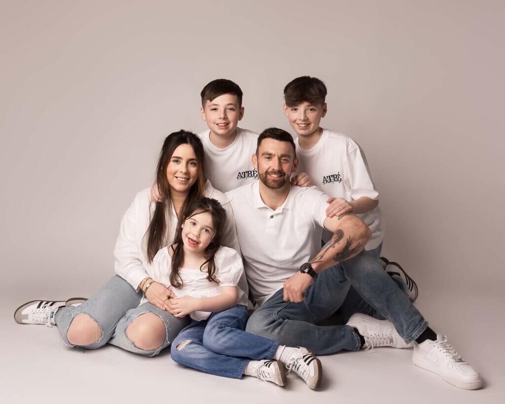 family with three children and their parents by family photographer in Belfast Northern Ireland
