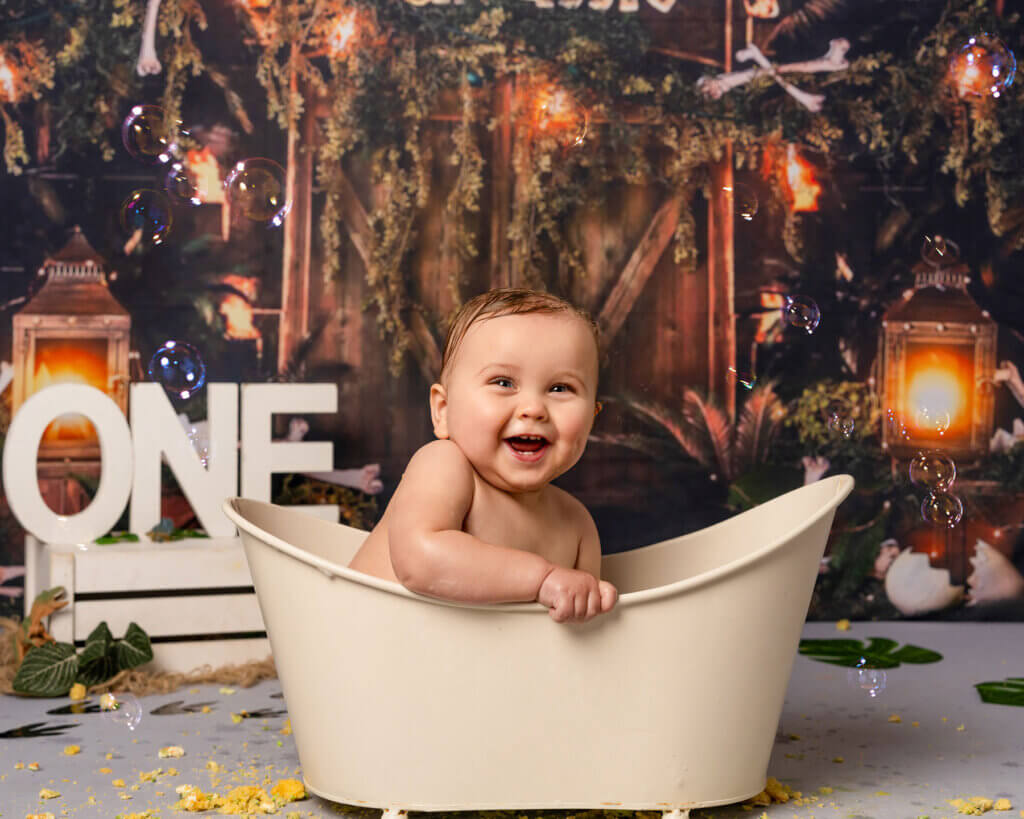 baby in a bathtub at the end of a cake smash photoshoot at a Cake Smash Belfast