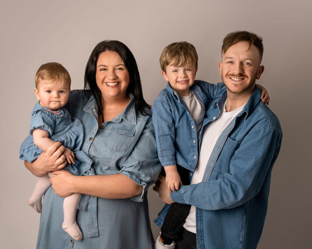 Family wearing coordinated colours and textures at Belfast photo session