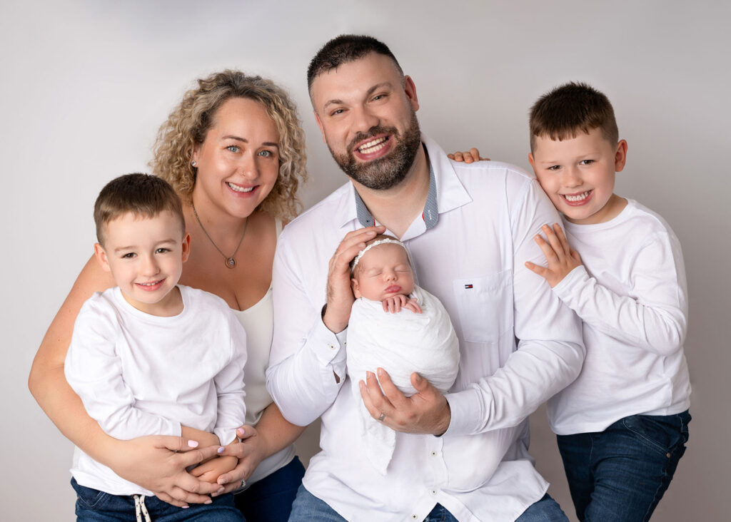 Family wearing neutral colour palette during studio photoshoot in Belfast